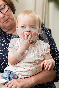 Grandmother holding her grandchild, happy family colorful