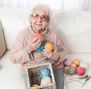 Grandmother holding knitting laces balls