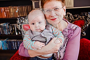 Grandmother holds a half-year-old grandson