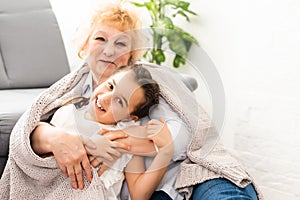 Grandmother hugging with her cute granddaughter