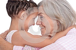 Grandmother hugging with her cute granddaughter isolated