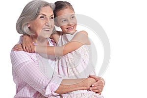 Grandmother hugging with her cute granddaughter isolated