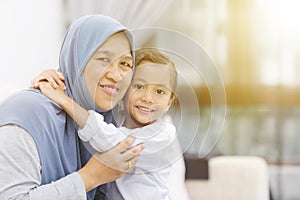 Grandmother hugging her granddaughter