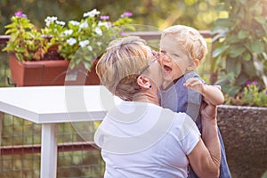 Grandmother and grandchild kisses