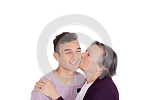 Grandmother kissing her teen grandson