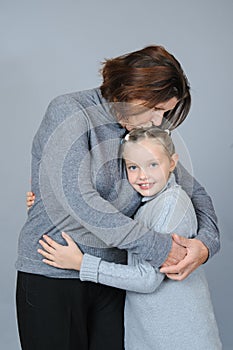 Grandmother kissing and hugging her granddaughter.