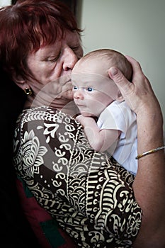 Grandmother Kissing Newborn Grandson