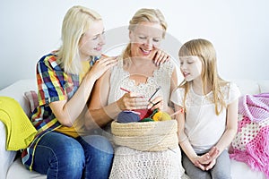 Grandmother knitting with granddaughter