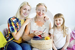 Grandmother knitting with granddaughter