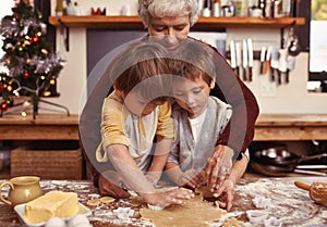 Grandmother, learning and kids baking at Christmas in kitchen, teaching and boys bonding together in family home