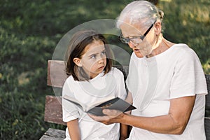 Grandmother and little girl reading holy bible. Study the holy bible together