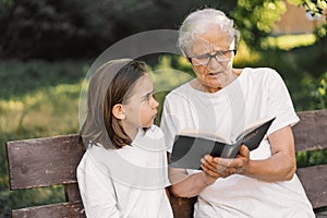 Grandmother and little girl reading holy bible. Study the holy bible together