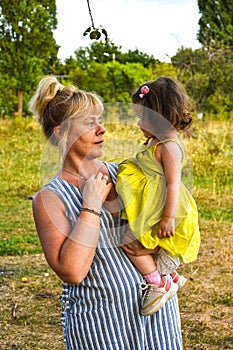 Grandmother, Mother And Daughter Relaxing In Park. Three generations are playing together in the garden.