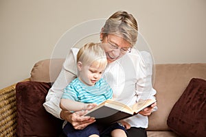 Grandmother or nanny reading to a child photo