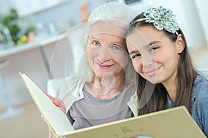 Grandmother read book for granddaughter