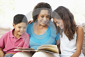 Grandmother Reading With Grandchildren photo