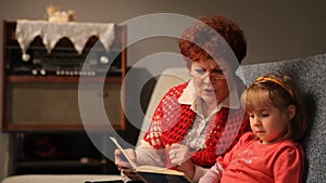 Grandmother reading a tale to her baby granddaughter.