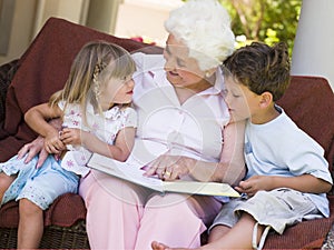 Grandmother reading to grandchildren