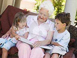 Grandmother reading to grandchildren