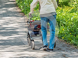 Grandmother with Rollator in the Park