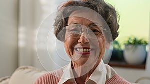 Grandmother senior woman old mature female elderly granny indoors at home smiling toothy looking camera happy middle