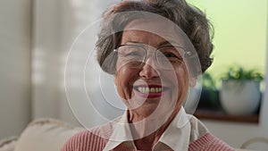 Grandmother senior woman old mature female elderly granny indoors at home smiling toothy looking camera happy middle