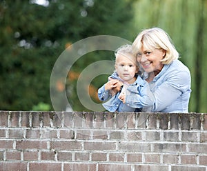 Grandmother smiling with baby girl outdoors