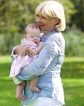 Grandmother smiling with baby granddaughter