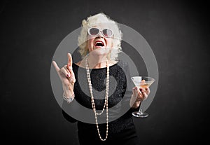 Grandmother with sunglasses and drink in hand