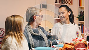 Grandmother talking with her daughter and granddaughter