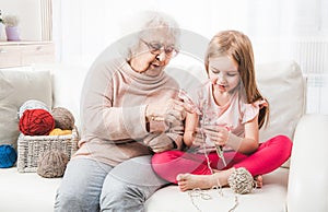 Grandmother teach granddaughter knitting