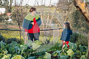 grandmother teaching her grandson about growing and harvesting in the garden