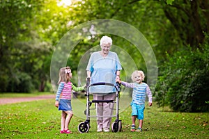 Grandmother with walker playing with two kids