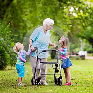 Grandmother with walker playing with two kids