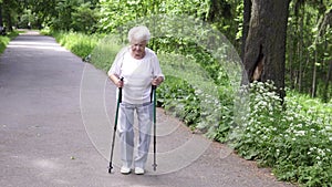 Grandmother walks with Nordic walking sticks old grey