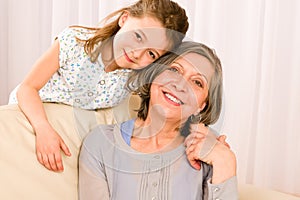 Grandmother with young girl smile relax together