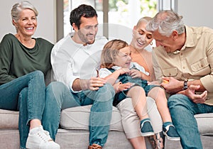 Grandpa brings the giggles. a happy family bonding on the sofa at home.