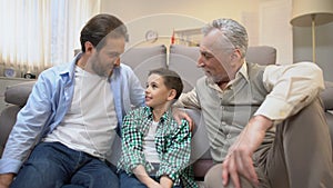 Grandpa and dad sharing experience with preteen boy, family bounds, togetherness