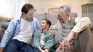 Grandpa and dad sharing experience with preteen boy, family bounds, togetherness