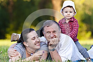 Grandpa, daughter and niece on grass photo