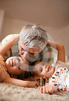 Grandpa and granddaughters playing.