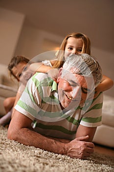 Grandpa and granddaughters playing. Fun on floor.