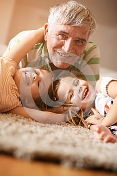 Grandpa and granddaughters playing. Fun and smile.