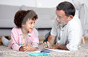 Grandpa and Grandson Boy Sketching And Talking In Living Room