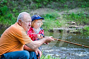 grandpa and grandson fishing together