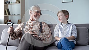 Grandpa and grandson laughing genuinely, joking, valuable fun moments together