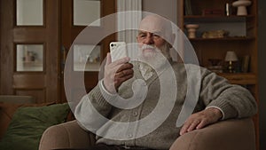 Grandpa Greeting on Video Call using Smartphone, senior man waving