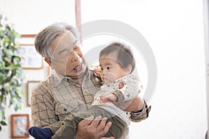 Grandpa holding his great-grandson