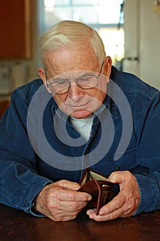 Grandpa looking in empty wallet