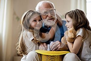 Grandpa playing with kids and looking inspired stock photo